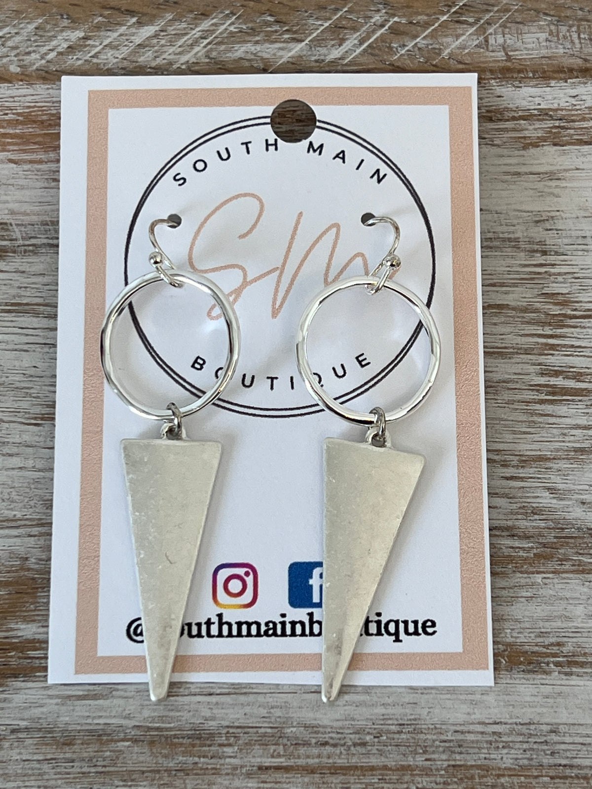 Worn silver pointed triangle earring